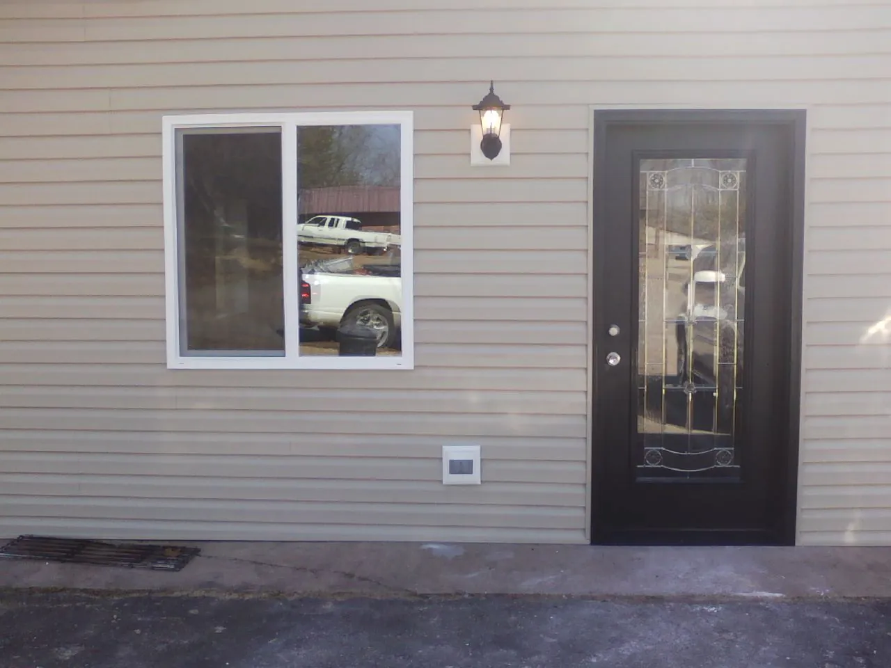 New siding, window and entry door on the side of an addition in Rogersville